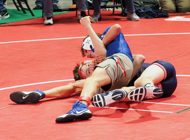 Logan Starr, top, of Westlake defeats Caden Garcia of Allen 13-3 in the first round of the UIL state wrestling meet Friday. [PAUL BRICK/FOR STATESMAN]