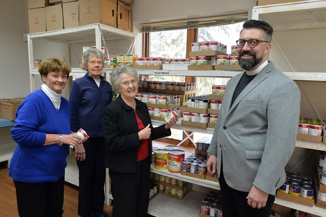 Calvary Episcopal Church members Marilyn Bradt, Lois Pryor and Carol Romine stands with Rector J. Clarkson in the groups old in Food Pantry. [PATRICK SULLIVAN/TIMES-NEWS]