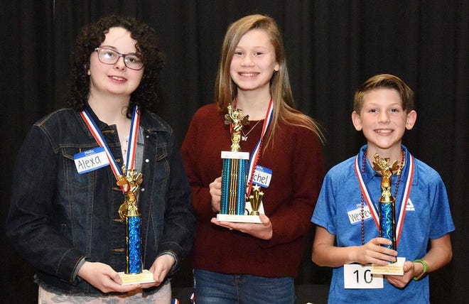 Rachel Noble, center, of Woodington Middle School and winner of the annual LCPS Spelling Bee held Tuesday night is flanked by Wesley Vernon of Southwood Elementary, first runner-up, and Alexa Hudson, Contentnea-Savannah K-8, second runner-up. [Contributed photo]