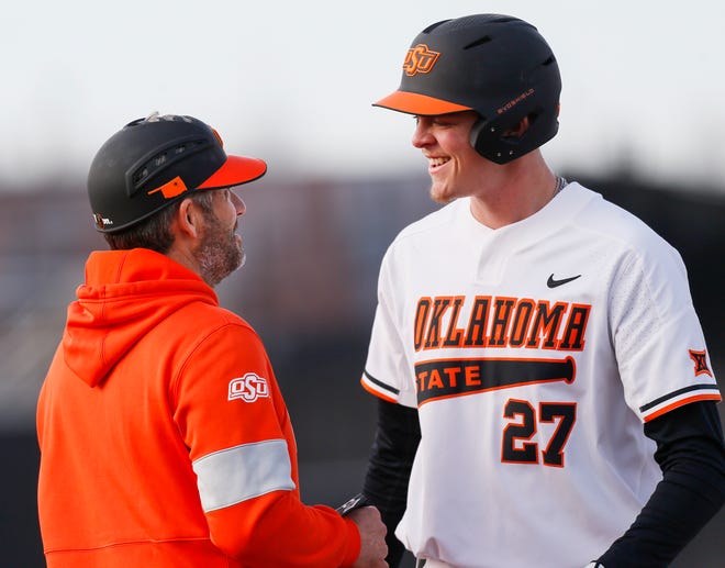 Rob Ventura, left, talks to OSU's Justin Campbell (27) in the third inning during a college baseball game between the University of Texas Rio Grande Valley Vaqueros and the Oklahoma State Cowboys, the OSU home opener, at Allie P. Reynolds Stadium in Stillwater, Okla., Friday, Feb. 21, 2020. Ventura is a student assistant for the Cowboys. [Nate Billings/The Oklahoman]