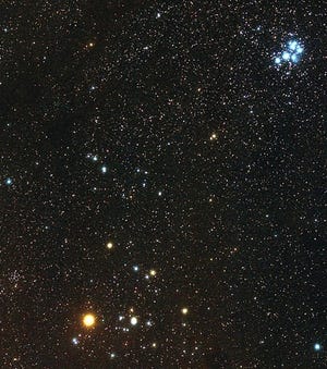 The red-orange star Aldebaran is at left, with the V-shaped Hyades star cluster. The Pleiades star cluster is at the top right. [Giuseppe Donatello/Wikimedia Commons/Public Domain]