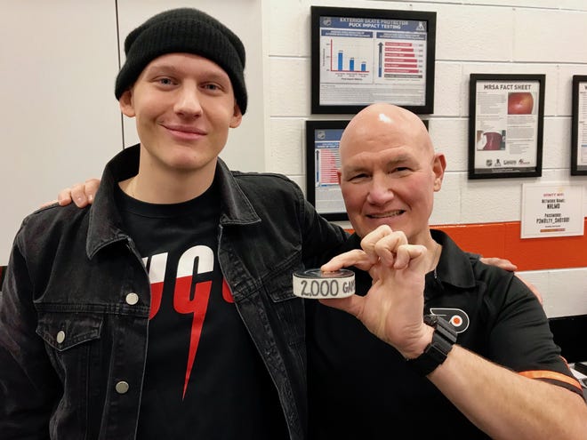 Oskar Lindblom (left), who is battling a rare form of bone cancer, on Saturday visited the Flyers, including director of sports medicine Jim McCrossin, who worked his 2,000th pro game. [ZACK HILL / FLYERS]