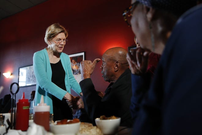 Democratic presidential candidate U.S. Sen. Elizabeth Warren, D-Mass., speaks with Bill Mamgum, center, and Shirley Mamgum Thursday at EllaEm's Soul Food in North Las Vegas, Nevada.  [AP Photo]