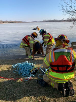 Lakeland firefighters bring two men who fell through the ice on Silver Lake to shore Sunday afternoon. [Branch County Sheriff photo]