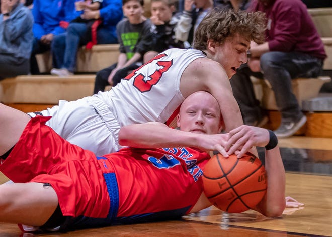Westlake Chaparrals forward Rory Munro, bottom, grabs a loose ball against Lake Travis Cavaliers guard Stephen Everett last month. The Chaps completed a perfect district campaign with a win over Austin High last week. [JOHN GUTIERREZ/FOR STATESMAN]