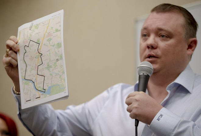 Matt Mackowiak holds up a map detailing an area where he would like to see rules restricting sitting or lying in public spaces put into effect during a news conference on Monday. Save Austin Now, a nonpartisan nonprofit launched by Mackowiak and Cleo Petricek, announced an effort to reinstate the ban on camping in public. [NICK WAGNER/AMERICAN-STATESMAN]