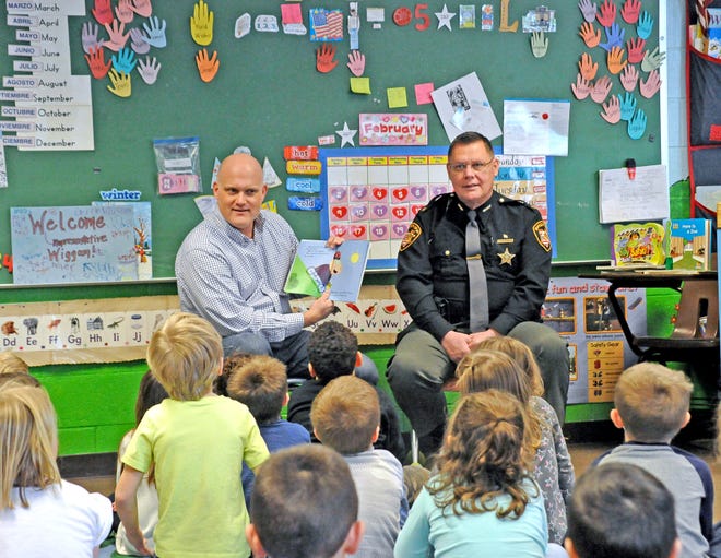 State Rep. Scott Wiggam (left) and Wayne County Sheriff Travis Hutchinson (right) served as guest readers for preschoolers at St. Mary in Wooster.