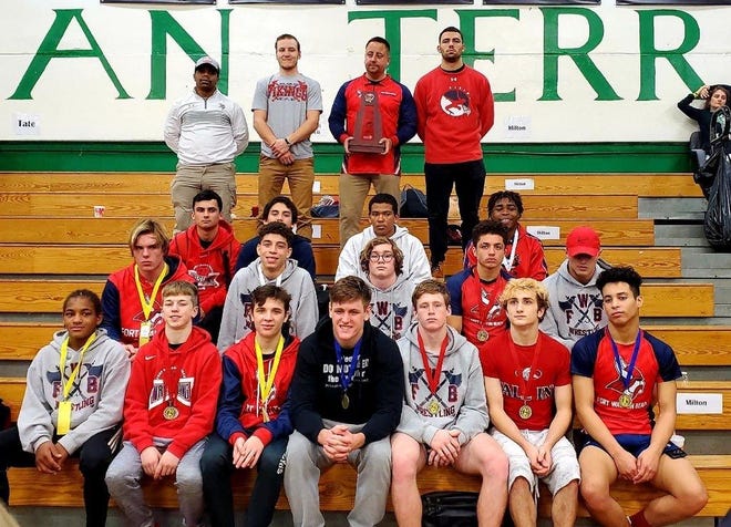 The Fort Walton Beach wrestling team poses with its trophy after taking second place at the District 1-2A tournament Saturday at Choctaw High School [CONTRIBUTED PHOTO]