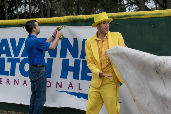 Savannah Bananas team president Jared Orton, left, and team owner Jesse Cole remove an advertising banner from the left-field wall on Monday. Grayson Stadium will be advertising-free starting with the 2020 season. [RANDY THOMPSON/SAVANNAHNOW.COM]