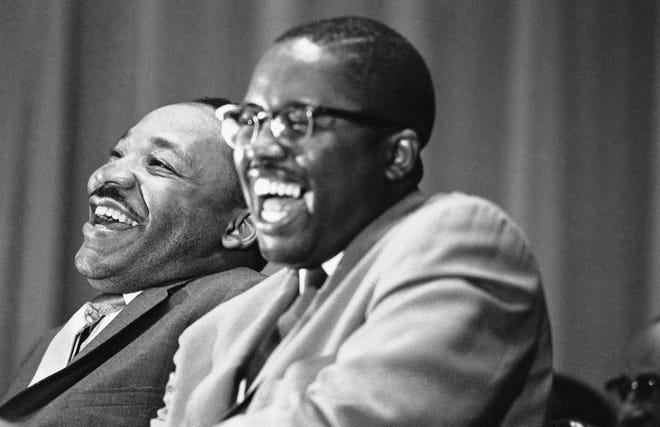 Civil rights leader Martin Luther King Jr., left, and attorney Fred D. Gray laugh at a joke told by a speaker at a political rally in Tuskegee, Ala., on April 29, 1966. King was on a whistle-stop tour through Alabama to encourage block-voting by blacks in the May Alabama primary. Gray was a candidate for a seat in the Alabama House of Representatives. [AP Photo/Jack Thornell]