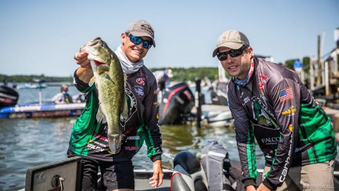 Defending national champions, Adam Puckett and Blake Albertson from Murray State University, show off a fish during last year’s finals on the Potomac River in Maryland. [COURTESY / FLW Fishing]