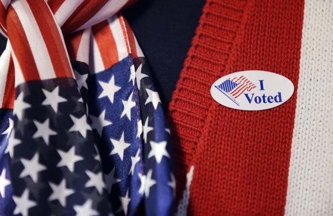 A voter wears a "I voted" sticker. [AP Photo/Darron Cummings, File]