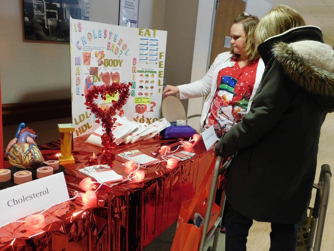 Marcia Bruce, cardiac rehabilitation nurse, left, discusses a display on heart health with a visitor during a Heart Month event Tuesday, Feb. 25, 2020, at Valley Health Services in Herkimer. [DONNA THOMPSON / TIMES TELEGRAM]