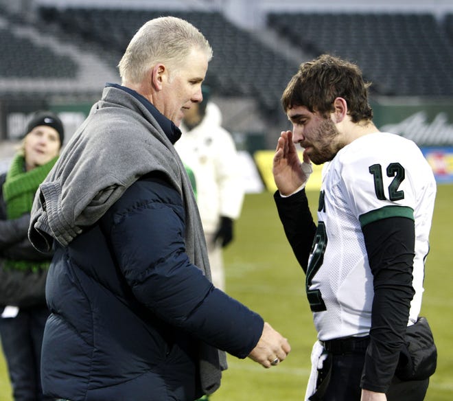 Quarterback Dillon Miller talks with his father, former NFL quarterback Chris Miller, after Sheldon's 47-14 loss to Lake Oswego in the OSAA 6A football Championship in 2011 at Jeld-Wen Field. (Brian Davies/The Register-Guard file)