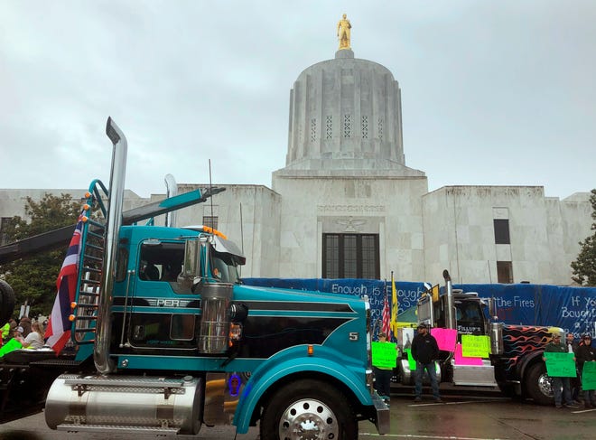 A convoy of trucks and tractors circles the Oregon state Capitol in June 2019. Protesters were supporting the 11 Republican senators who walked out to avoid a vote on climate legislation. (AP Photo/Sarah Zimmerman, file)