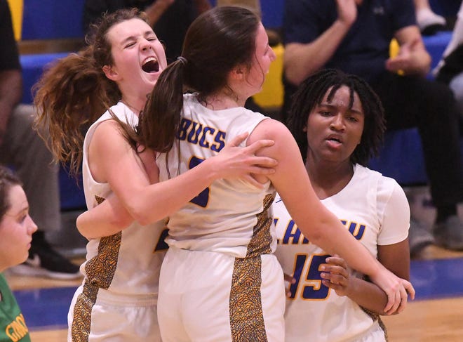 Laney's #24 Taylor Chism #3 Regan Stewart and #15 Jackie Hill celebrate after Laney beat Cardinal Gibbons 51-46 in the first round of the NCHSAA 4A Playoffs Tuesday Feb. 25, 2020 at Laney in Wilmington. N.C. [KEN BLEVINS/STARNEWS]