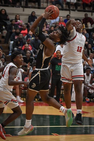 Topeka High junior Jalen Smith (1) drives to the basket Tuesday night at Highland Park. Smith scored a game-high 19 points as the Trojans edged the Scots, 54-52. [Rex Wolf/Special to The Capital-Journal]