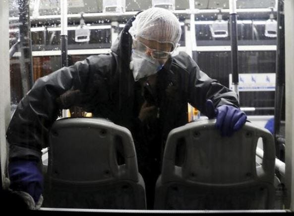 A worker disinfects a bus against the coronavirus in Tehran, Iran, on Wednesday February 26, 2020. [ASSOCIATED PRESS]