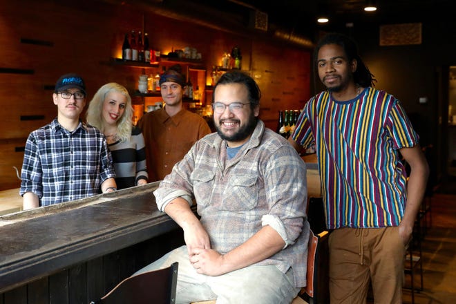 James Mark, center, sits at the bar in his restaurant Big King, along with cooks Oscar Lange, left, Emily Joslyn, Peter Kachmarsky and JC Kuvaszko. Mark employs fewer than 50 people so he isn't required to provide health benefits, but he does anyway because he thinks it helps with staff retention and is the right thing to do. [Christine Chitnis/Kaiser Health News/TNS]