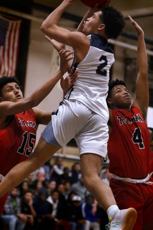 Tolman defenders Jaylin Baptista and Sulayman Faal try to stop Shea's Erickson Bans in a Feb. 12 game. Bans scored 28 points as Shea won, 62-56. [The Providence Journal / Kris Craig]