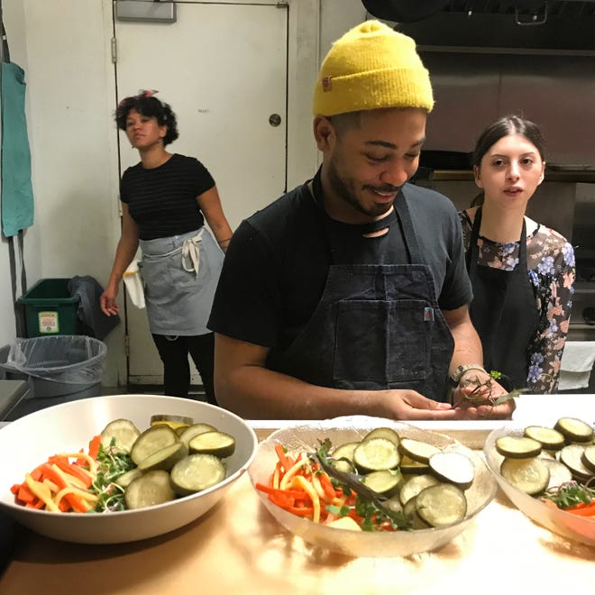 Isaiah Martinez of Yardy Eugene plating pickles at a pop-up supper for Black History Month. [Isaiah Martinez]
