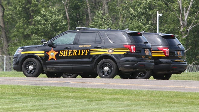 Two Stark County Sheriff's Office patrol cars are shown outside the Stark County Safety Building in Canton. [Scott Heckel/CantonRep.com file]