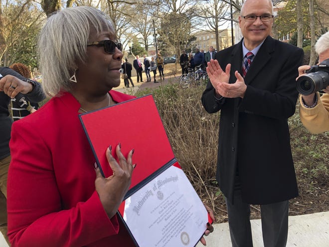 Linnie Liggins Willis holds her 1970 University of Mississippi diploma that she received from the university's provost, Noel Wilkin, on Tuesday, Feb. 25, 2020, on the Ole Miss campus in Oxford, Miss. [AP Photo/Brittany M. Brown]