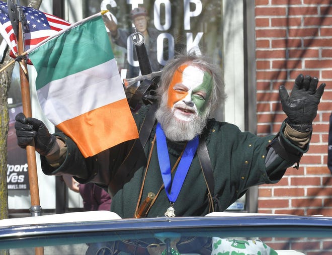 Harry Donnelly of the Warwick Ancient Order of Hibernians waves to paradegoers during the St. Patrick's Day Parade in Newport. [DAILY NEWS FILE PHOTO]