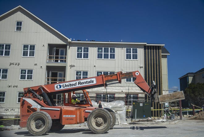 Construction crews work at the Mont Apartments, which is under construction at Montopolis Drive and Grove Boulevard in Southeast Austin.  More than 25,000 apartment units are under construction in the Austin metro area, with half of those likely to open this year, according to Capitol Market Research. [RICARDO B. BRAZZIELL/AMERICAN-STATESMAN]