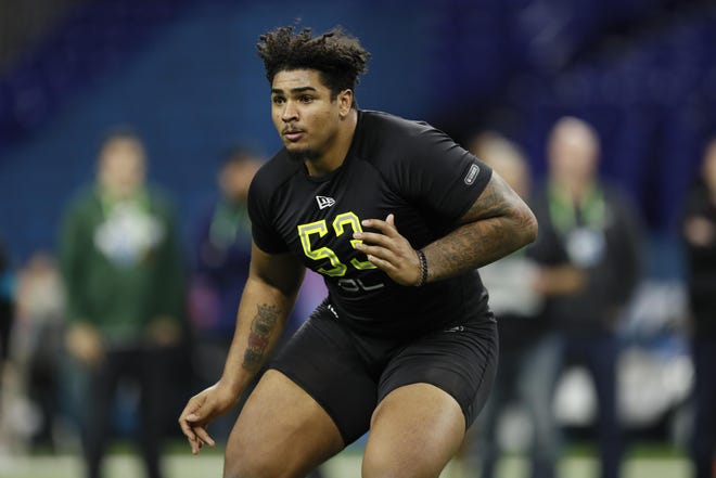 Iowa offensive lineman Tristan Wirfs runs a drill Friday at the NFL Scouting Combine in Indianapolis. [Charlie Neibergall/The Associated Press]