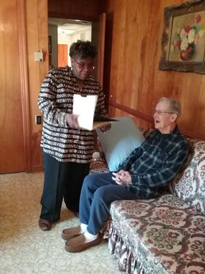 Gaston Hospice Chaplain Lisa Marshall presents a Certificate of Appreciation to 94 year-old Navy veteran B.J. Keller Jr. [PHOTO PROVIDED BY MELODIE STARR]
