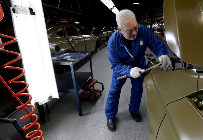 Joe Nickowski, 62 of Taylor, works at getting a small bump out of a 2020 Chevrolet Impala before it would be sent for final paint on Thursday, February 20, 2020 inside the GM Detroit-Hamtramck Assembly plant. The car is nearing its end of production as the plant is being retooled and fitted for electric vehicles. (Eric Seals/Detroit Free Press/TNS)