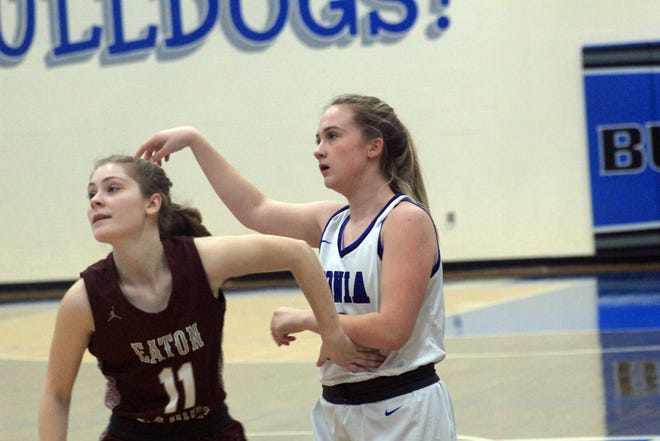 Melayna Braman of Ionia (right) follows through on her shot Loralei Berry of Eaton Rapids defends during a girls varsity basketball game on Friday, Feb. 28, at Ionia High School. Eaton Rapids won 47-34. [Evan Sasiela/Sentinel Staff]