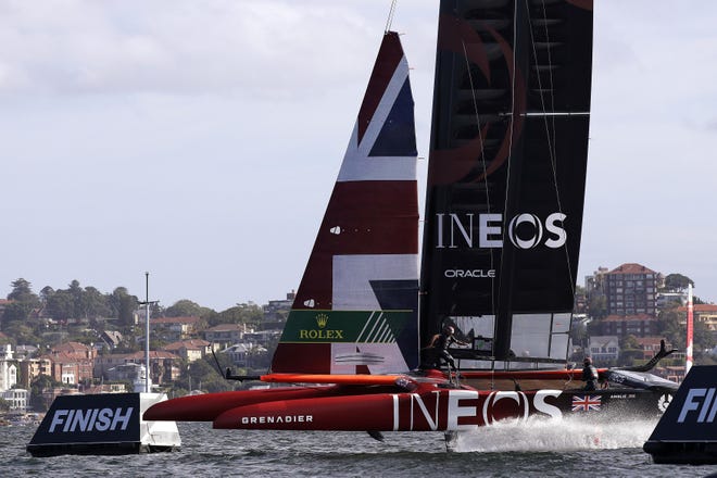 Britain's Ben Ainslie guides the boat past the finish line in the third race of the SailGP event in Sydney on Friday. [THE ASSOCIATED PRESS]