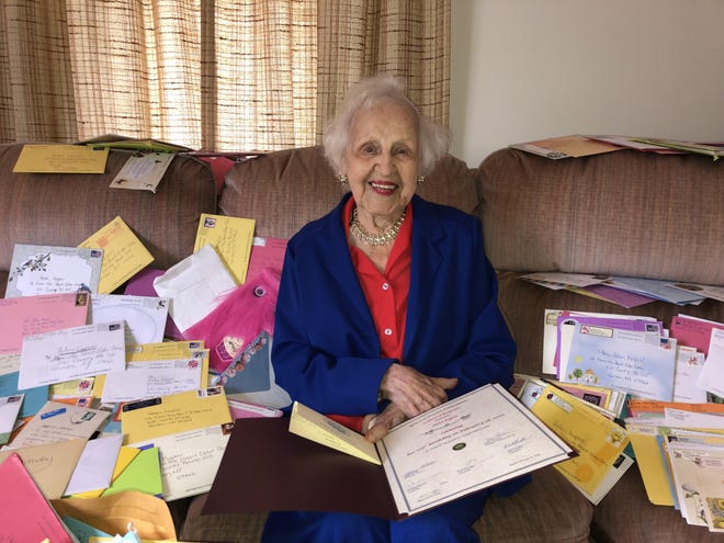 Helen Kaposi, surrounded by some of the more than 4,000 birthday cards that she received for her 105th birthday. She is holding the Certificate of Recognition and card from the Sussex County Board of Chosen Freeholders. [Photo by Jennifer Jean Miller/New Jersey Herald (NJH)]