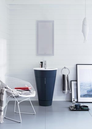 This photo shows Duravit's Starck 1 barrel vanity and is now available in an inky blue. The color and unique shape make it a standout piece in bathrooms of any size. [Duravit]