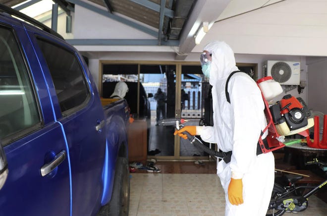 A Thai health officer wearing a protective suit sprays disinfectant. [Bangkok Governor’s office via AP]