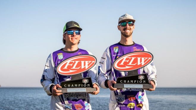 The winning team from Stephen F. Austin University, Christopher Harrison and Ethan LeGare, pose for pictures with the national championship trophies on Friday after winning the FLW college national championship on the Harris Chain of Lakes. [COURTESY / FLW FISHING]