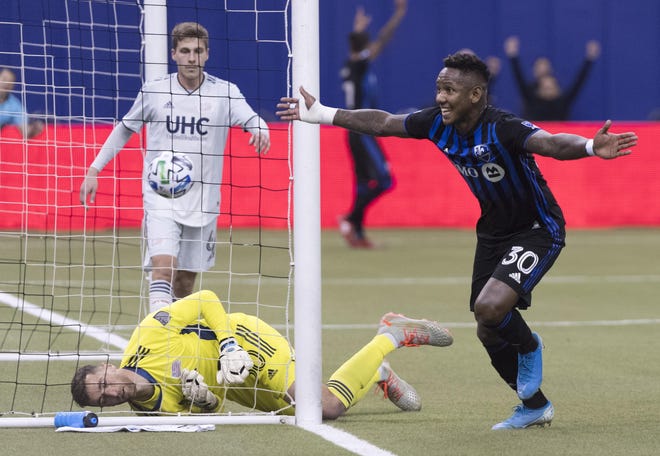 The Impact's Romell Quioto reacts after scoring past Revolution goalkeeper Matt Turner during the first half of Saturday’s match in Montreal. [The Canadian Press via AP / Graham Hughes]
