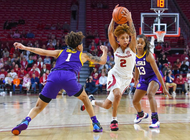 Razorback senior guard Alexis Tolefree (#2) from Conway splits a double-team against LSU Sunday night at Bud Walton Arena in Fayetteville. [Craven Whitlow special to the Times Record]