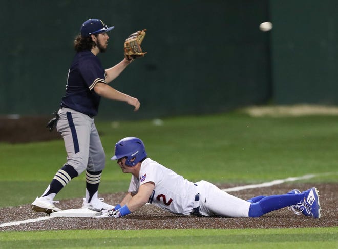 Sage Luther slides safely into third base during the 12-0 win by Westlake over Akins on Feb. 25 at Westlake High School. [PAUL BRICK FOR STATESMAN]