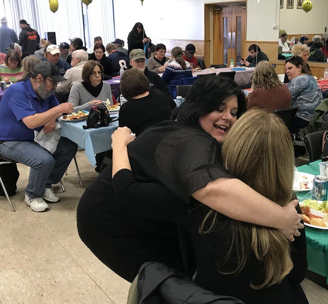 Angelina Youngman gets a hug from Diane Gargano Sunday during a fundraiser at the Corning Local 1000 Union Hall. [JEFF SMITH/THE LEADER]