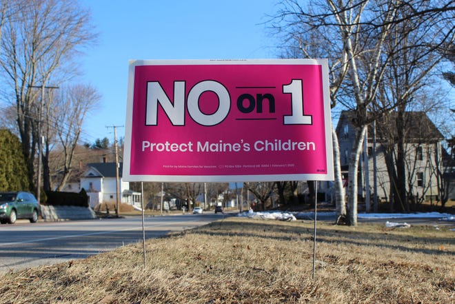A yard sign in York, Maine, encourages voters to reject a ballot referendum that sought to restore religious and philosophical exemptions to the state’s vaccination requirements in schools and health care facilities. [Steven Porter/Seacoastonline]