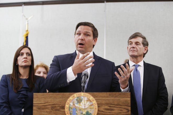 Lieutenant Governor Jeanette Nunez, left, and State Surgeon General Dr. Scott Rivkees look on while Florida Governor Ron DeSantis speaks about Florida's confirmed coronavirus cases on Monday, March 2, 2020 at the Florida Department of Health Laboratory in Tampa, Fla. (Octavio Jones/Tampa Bay Times/TNS)