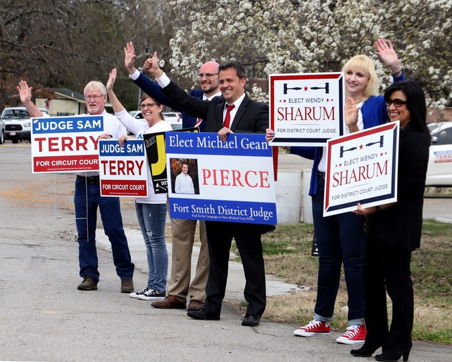 Candidates and volunteers line up at the entry to Creekmore Park with signs supporting their choice in the local elections, Tuesday, Mar. 3, 2020. [JAMIE MITCHELL/TIMES RECORD]