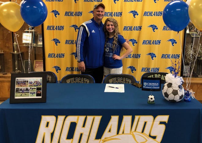 Richlands High School senior Madison "Pippi" Anderson is joined by coach Mike Roed after she recently committed to play soccer at Chowan University. [Contributed Photo]