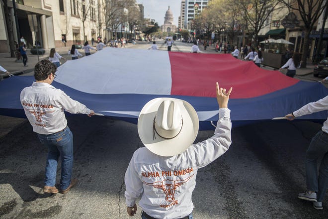 Alphi Phi Omega Service organization marched during the Texas Independence Day parade on Congress Avenue on March 3, 2018. [RICARDO B. BRAZZIELL / AMERICAN-STATESMAN / FILE]