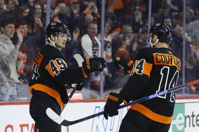 The Flyers' Joel Farabee, left, and Sean Couturier celebrate a goal against the Avalanche. [MATT SLOCUM / ASSOCIATED PRESS FILE]