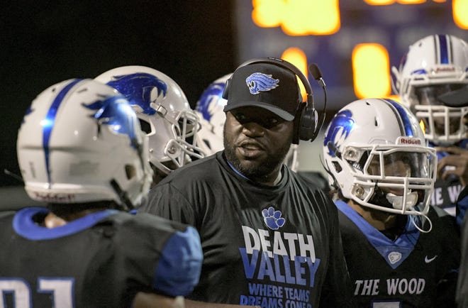 Wildwood head football coach J.B. Bynum talks with his players during a game in 2018 against The Villages at Wildwood. Bynum confirmed on Thursday that he had been fired after two seasons as Wildcats head coach. [PAUL RYAN / CORRESPONDENT]