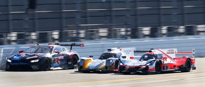 The No. 6 Acura DPi works around the No. 38 Oreca LMP2 07 and the No. 24 BMW M8 GTE on the backstretch of the Rolex 24 at Daytona International Speedway in January. The race sparked gains in hotel occupancy, room rates and revenue for Volusia County hotels. [N-J/David Tucker]